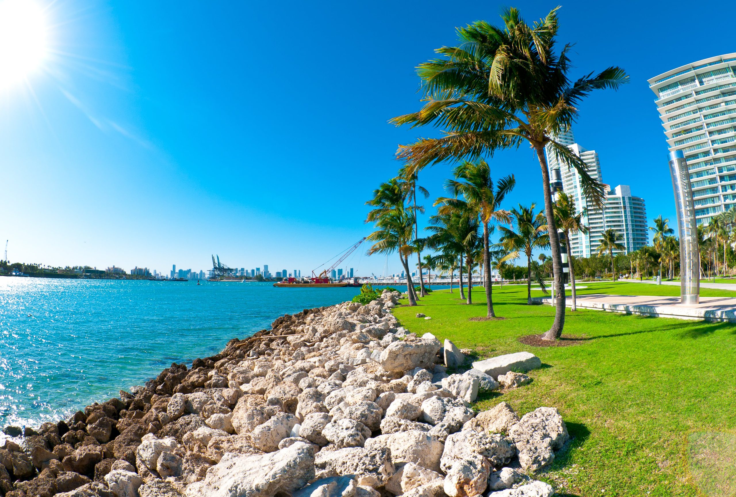 View of waterway used to enter Miami Seaport with city in the background and recreational park at the side